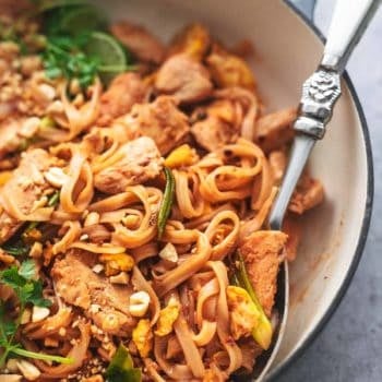 up close view of noodles with eggs and peanuts and cilantro in a skillet