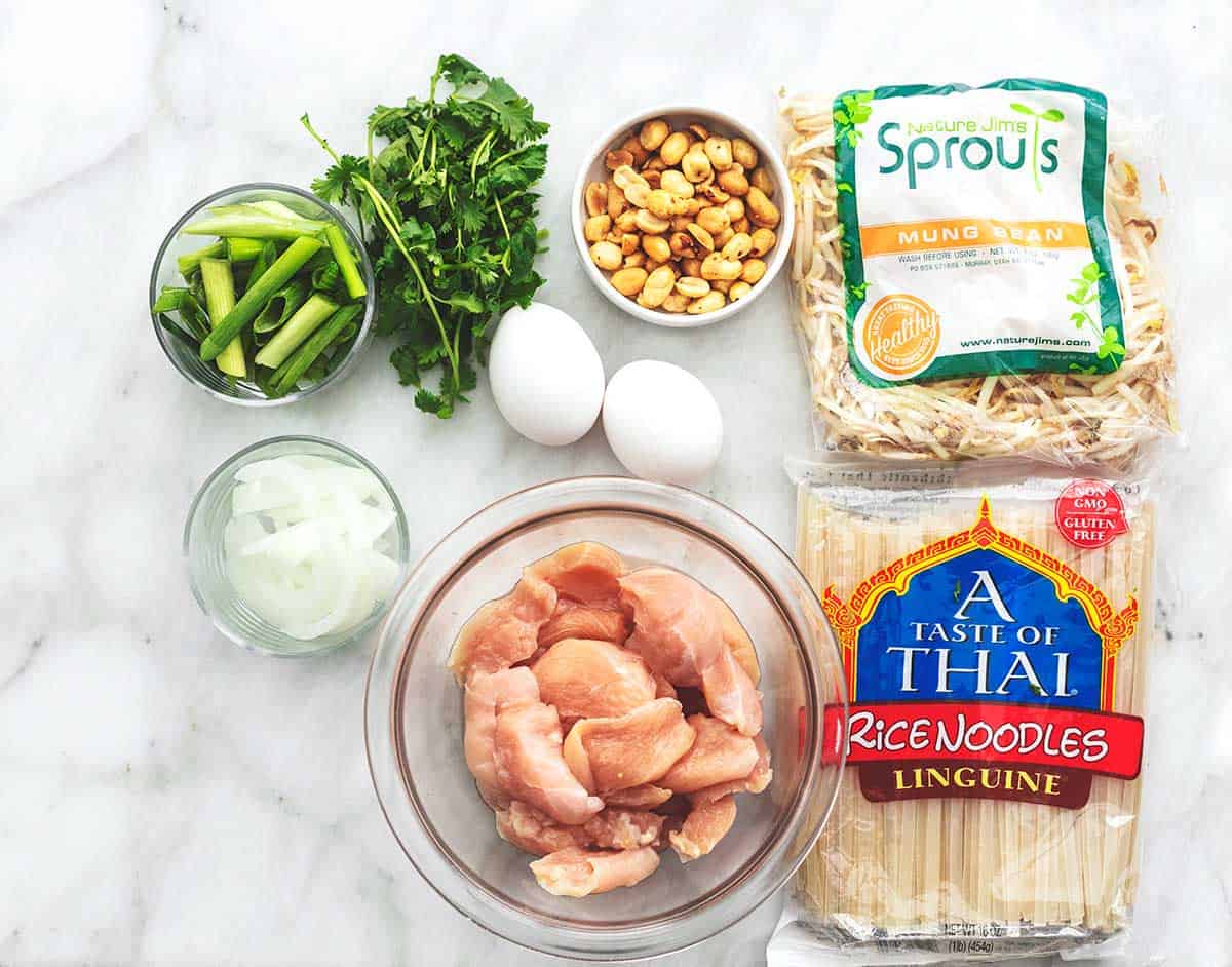 ingredients for chicken pad thai on a marble tabletop