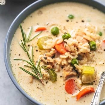 up close view of 3/4 of a bowl of soup with chicken, vegetables, and rice with rosemary