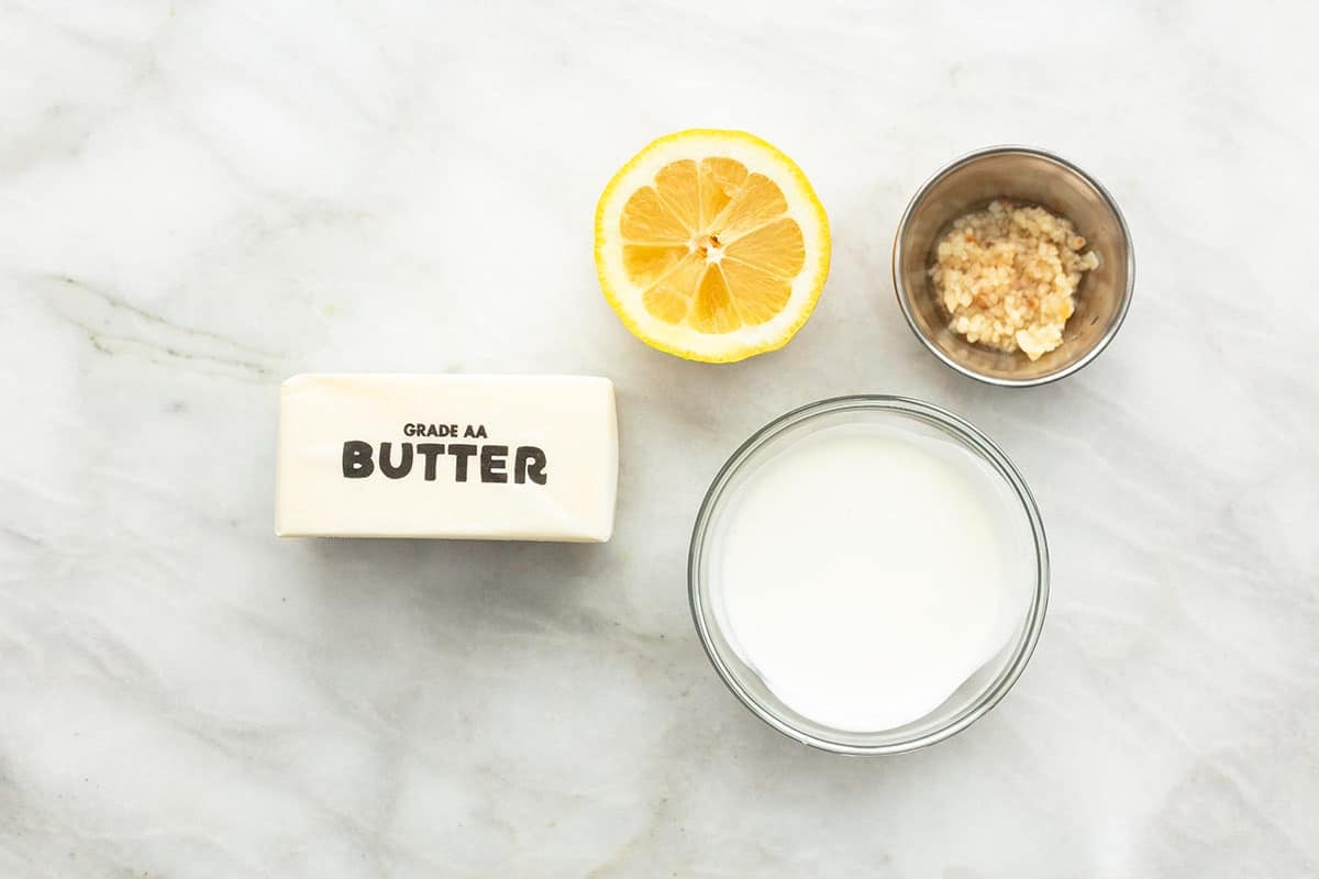 top view of ingredients for lemon butter sauce on a tabletop.