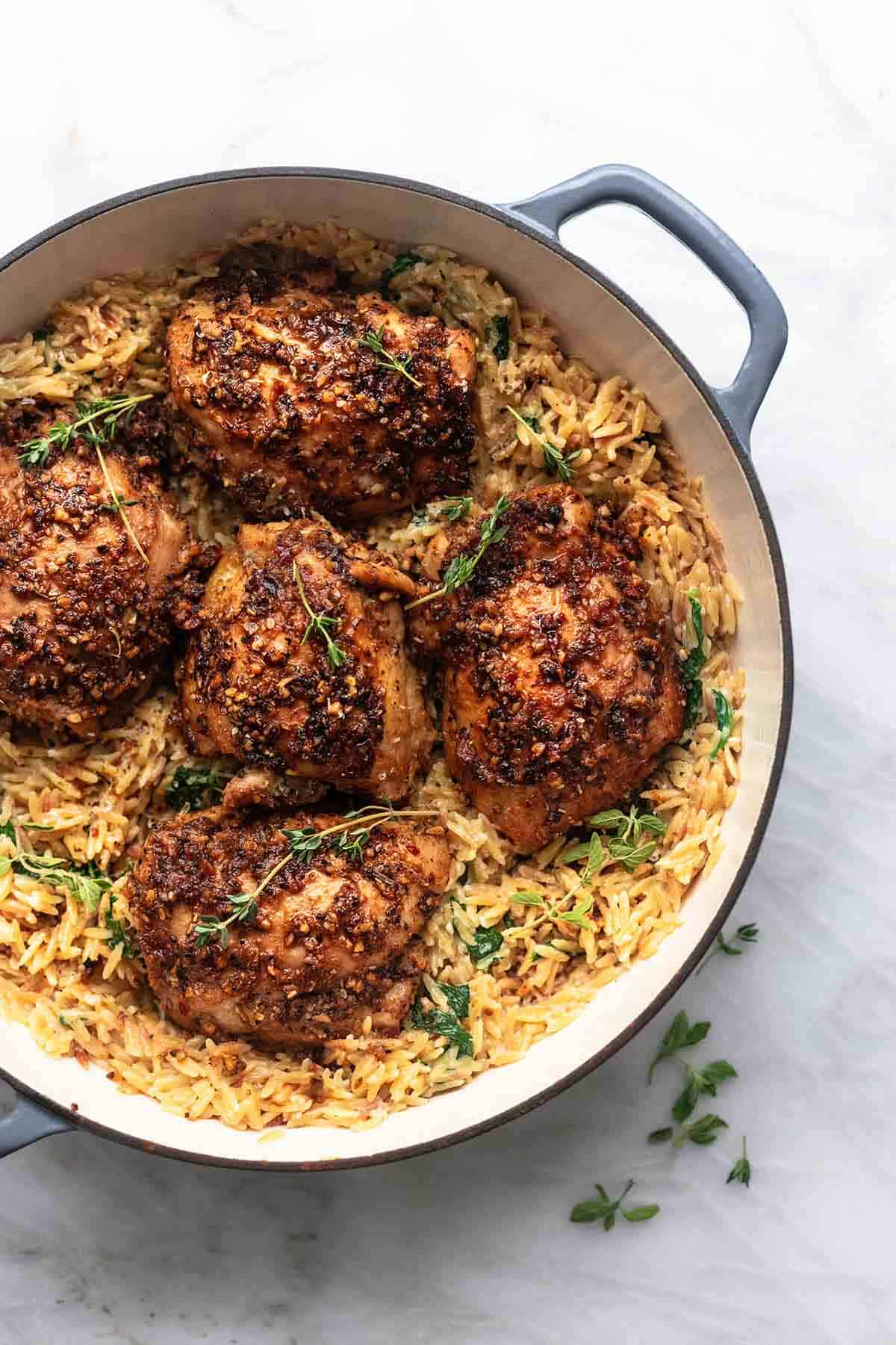 close up top view of Green chicken and orzo in a pot.