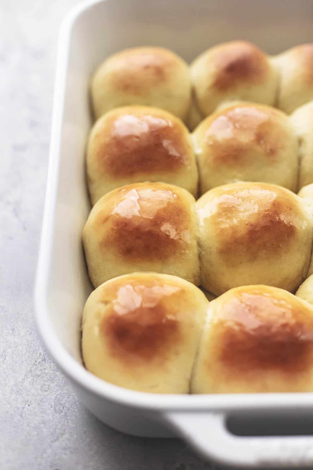 close up of buttermilk dinner rolls in a baking pan.