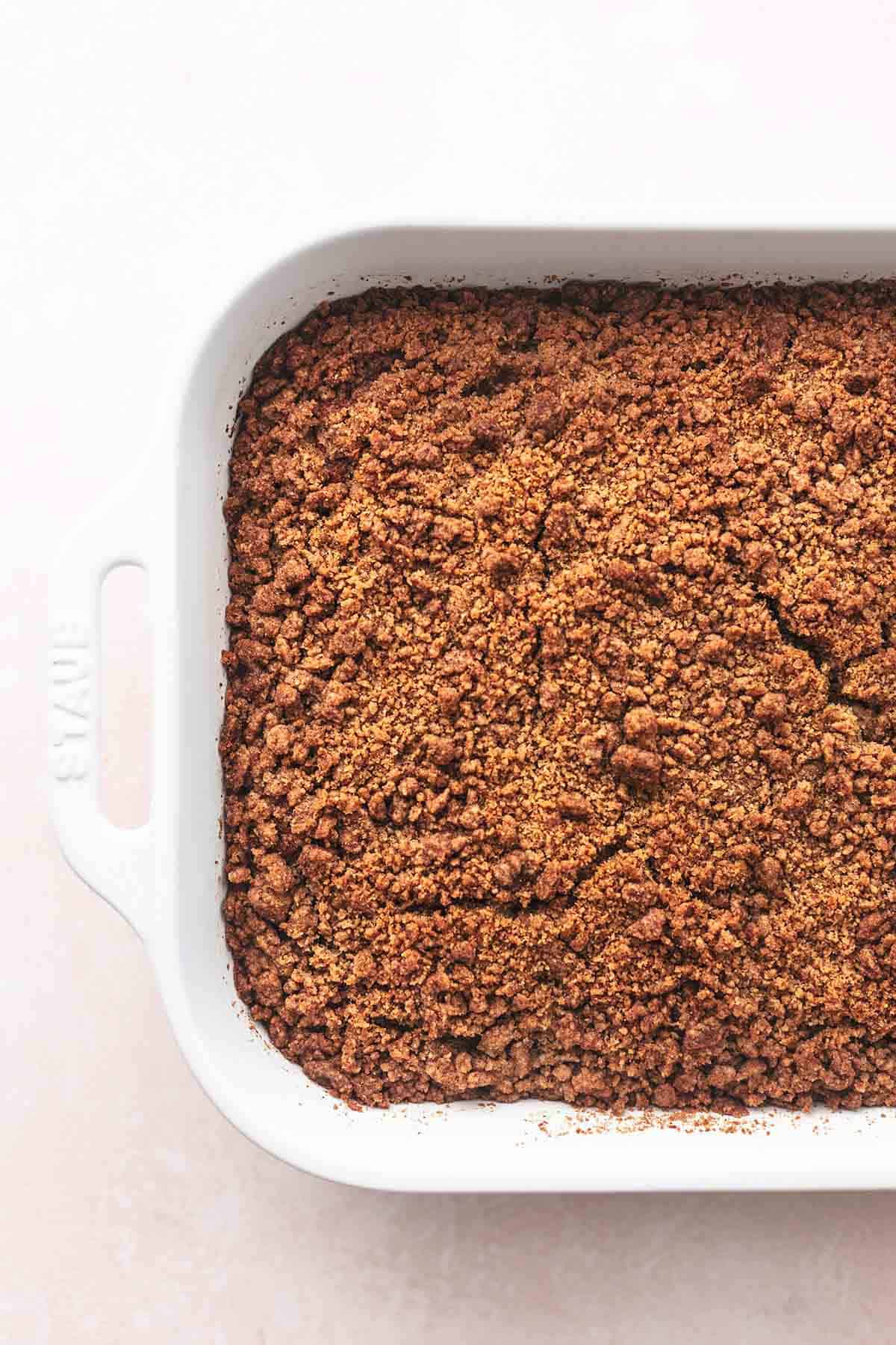 close up top view of apple cinnamon coffee cake in a baking pan.