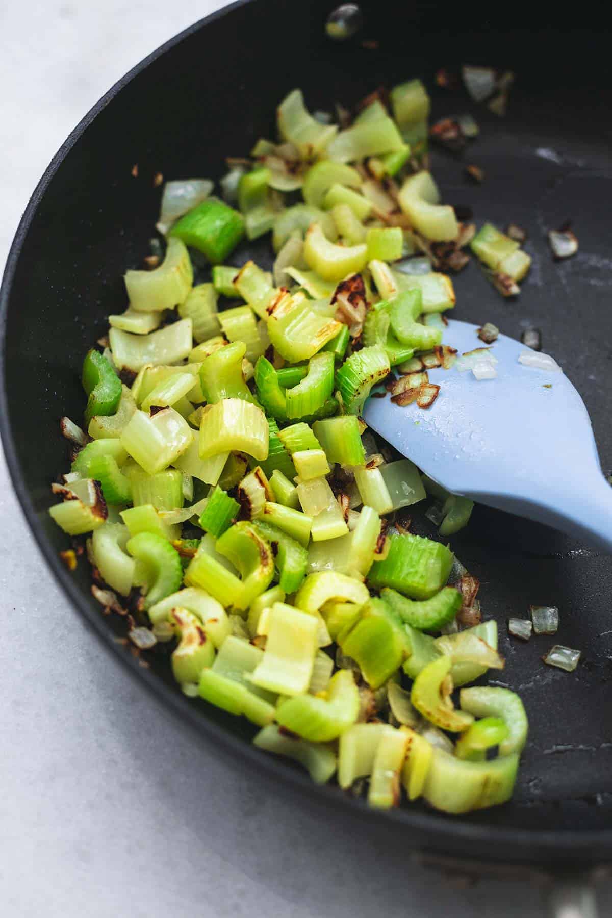 cooked celery and onions in a skillet