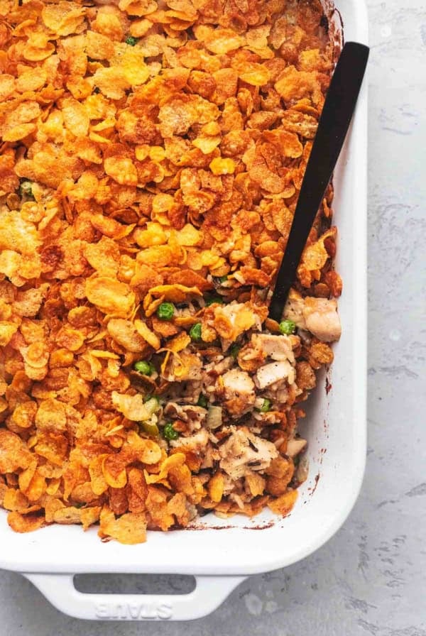 overhead view of black serving spoon in white casserole dish