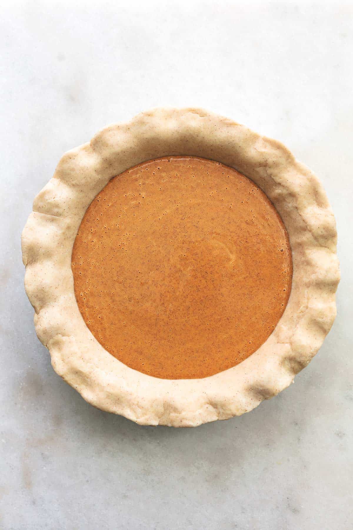 top view of unbaked pumpkin pie in a pie tin.