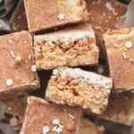 rice krispie bars with sprinkles in a holiday tin