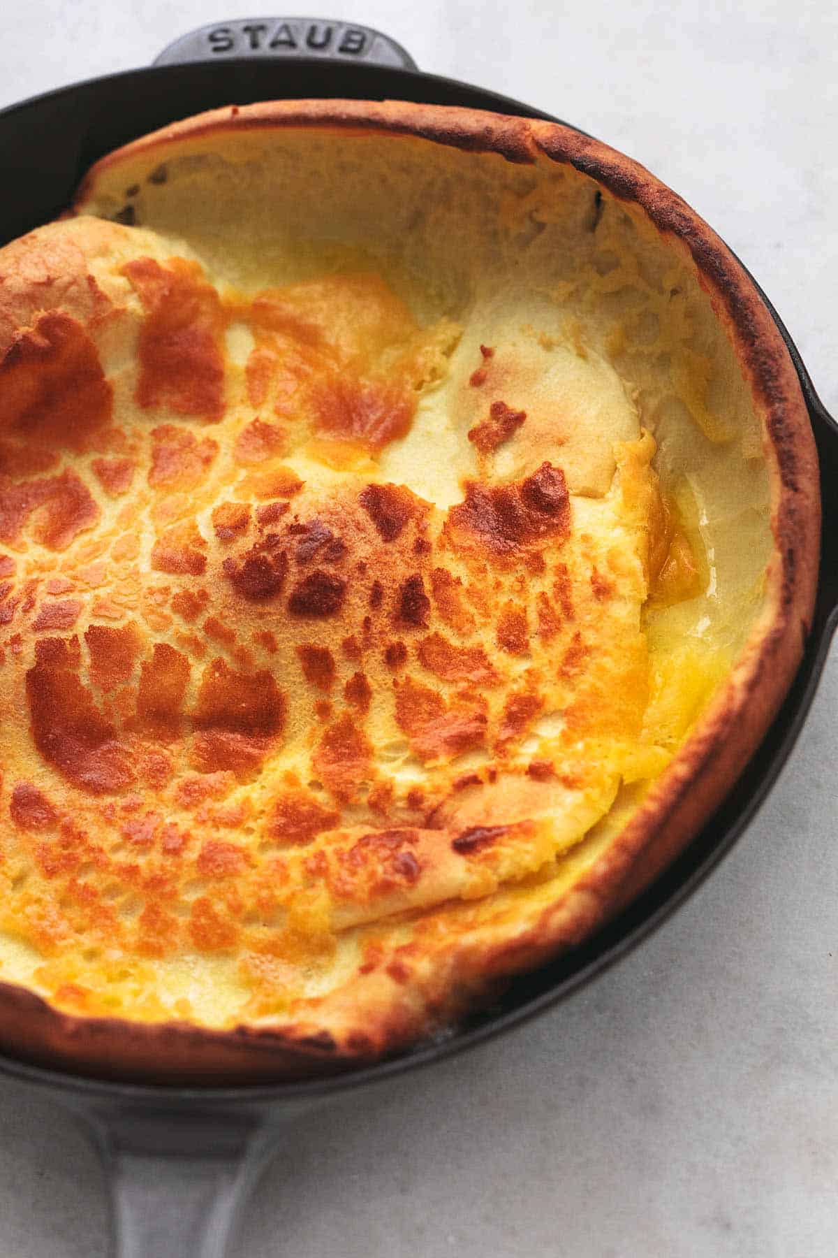 dutch baby without toppings in cast iron pan.