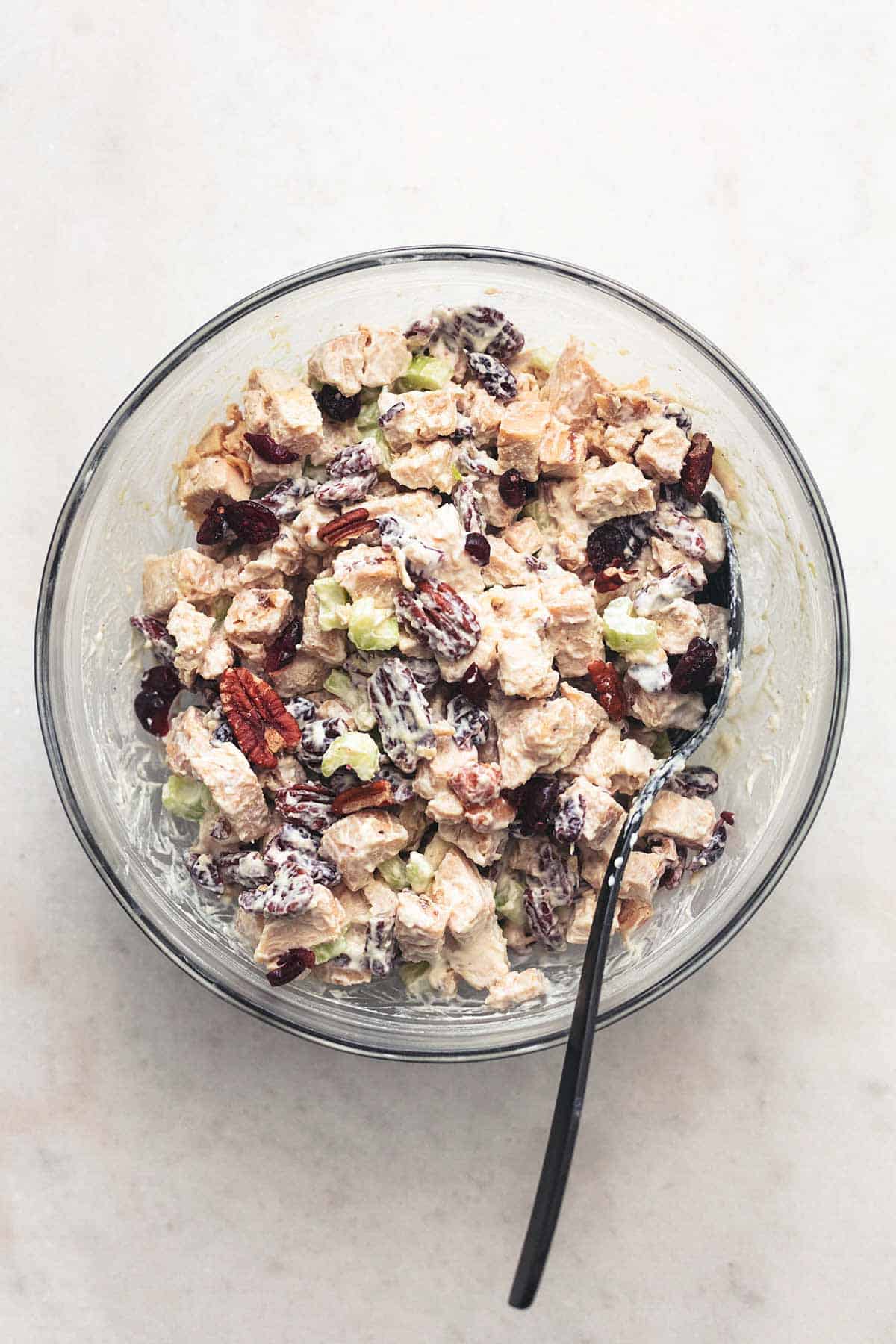 overhead view of chicken or turkey mixture with pecans and creamy sauce in a bowl