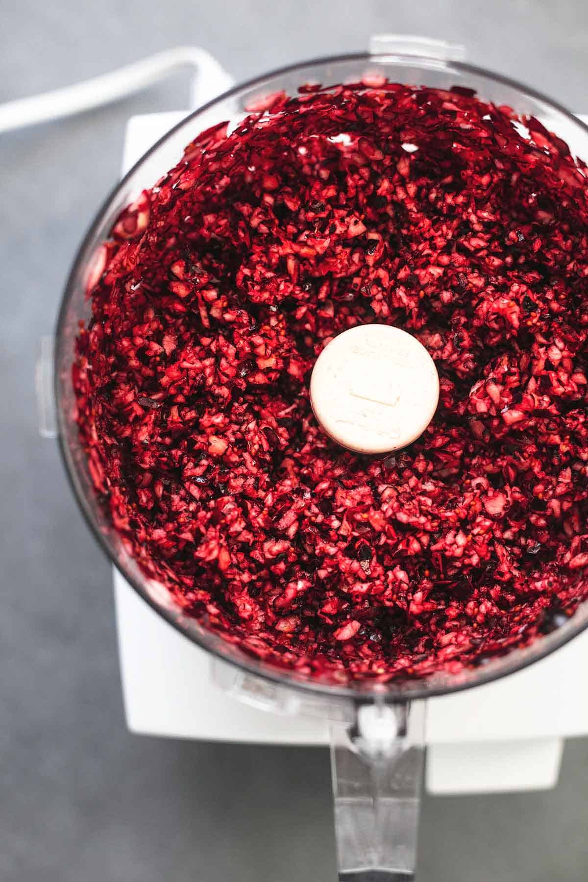 overhead view of chopped fresh cranberries in a food processor