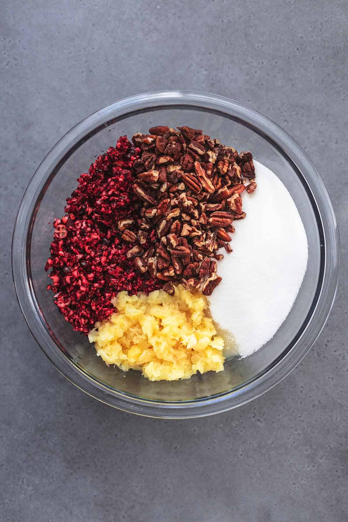 ingredients for cranberry salad in a glass bowl, unmixed