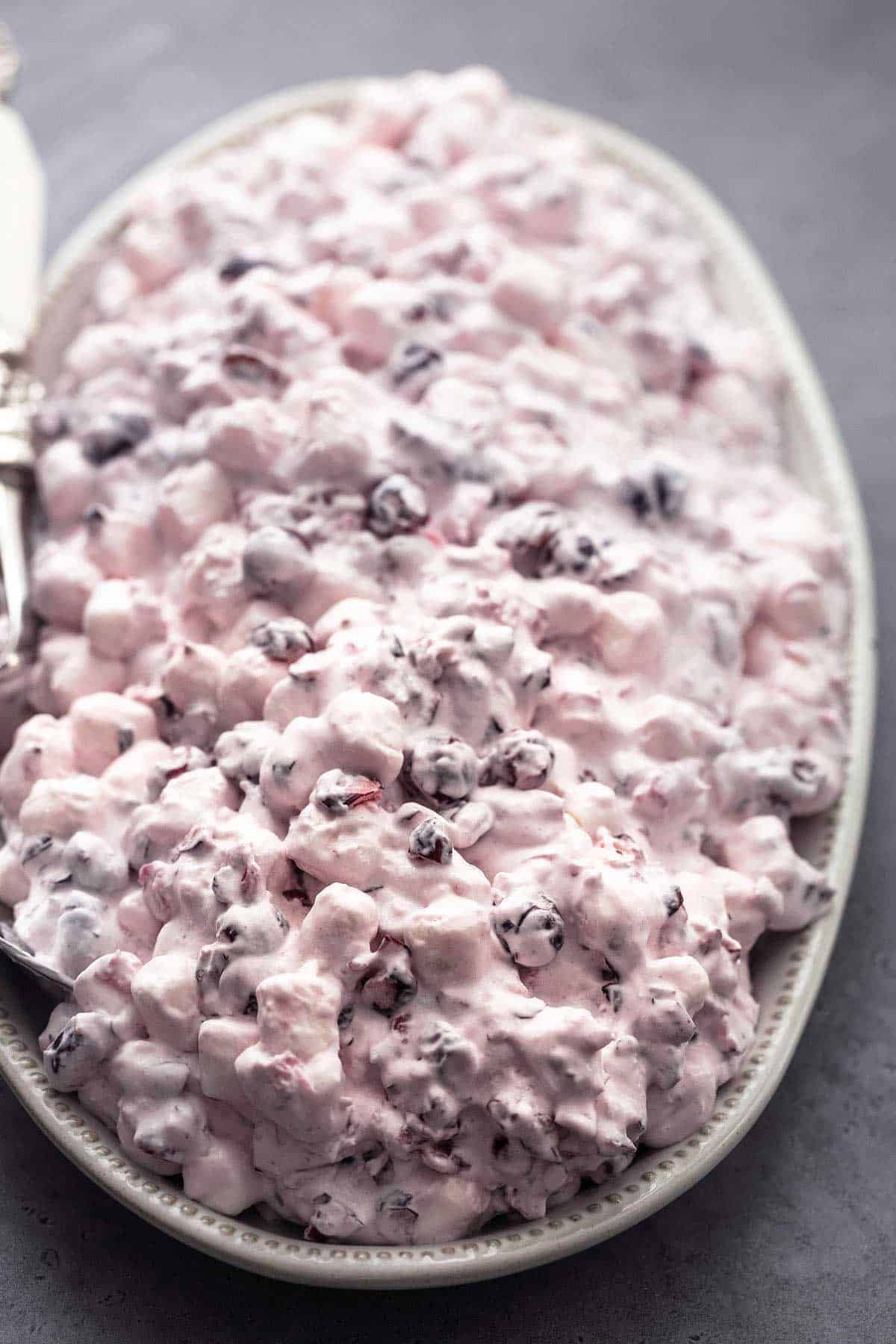 up close view of creamy marshmallow and berry mixture on a platter