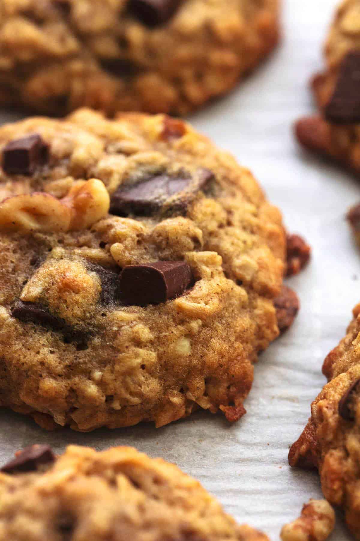 close up of a chunky monkey banana cookie with more cookies around it.