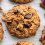 up close brown cookie with walnut pieces and chocolate chunks