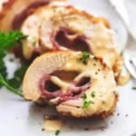 sliced chicken cordon bleu with creamy sauce on a plate