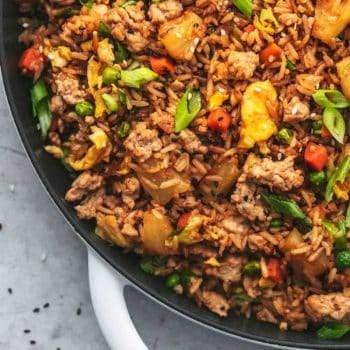 up close quarter of a cast iron skillet filled with asian rice dish