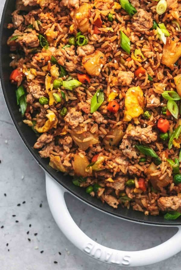 up close quarter of a cast iron skillet filled with asian rice dish