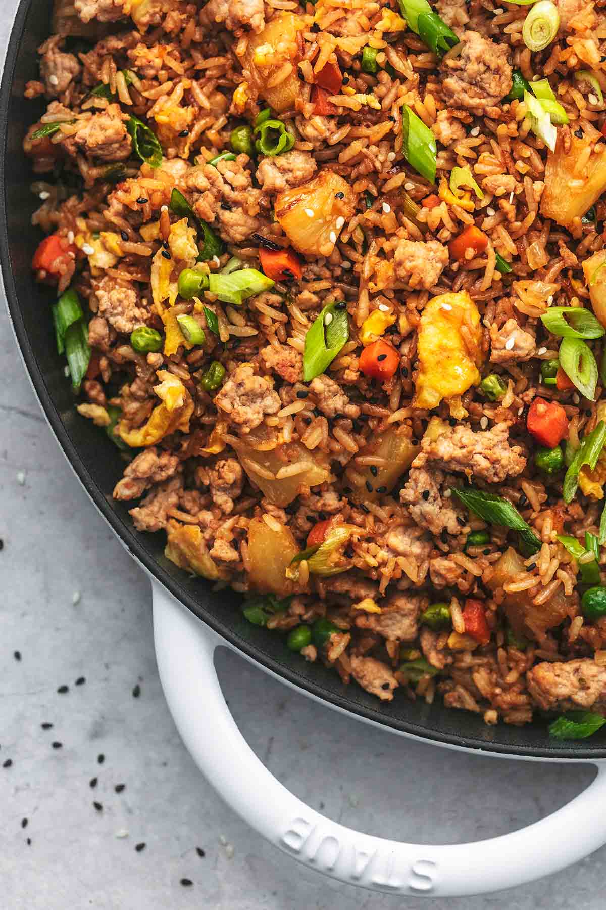 close up top view of pork fried rice in a skillet.