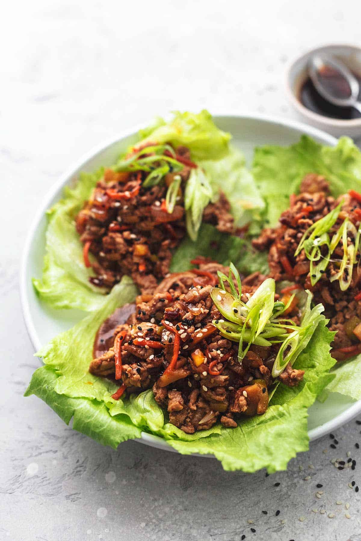 three lettuce wraps on plate