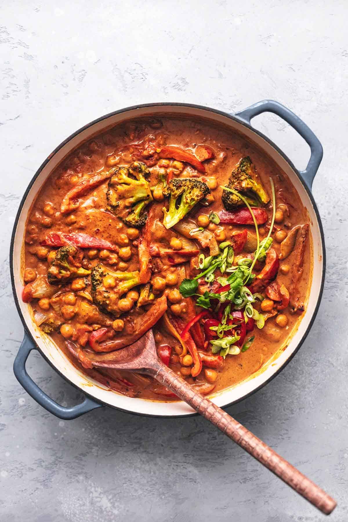 overhead view of skillet with red sauce, vegetables, and chickpeas