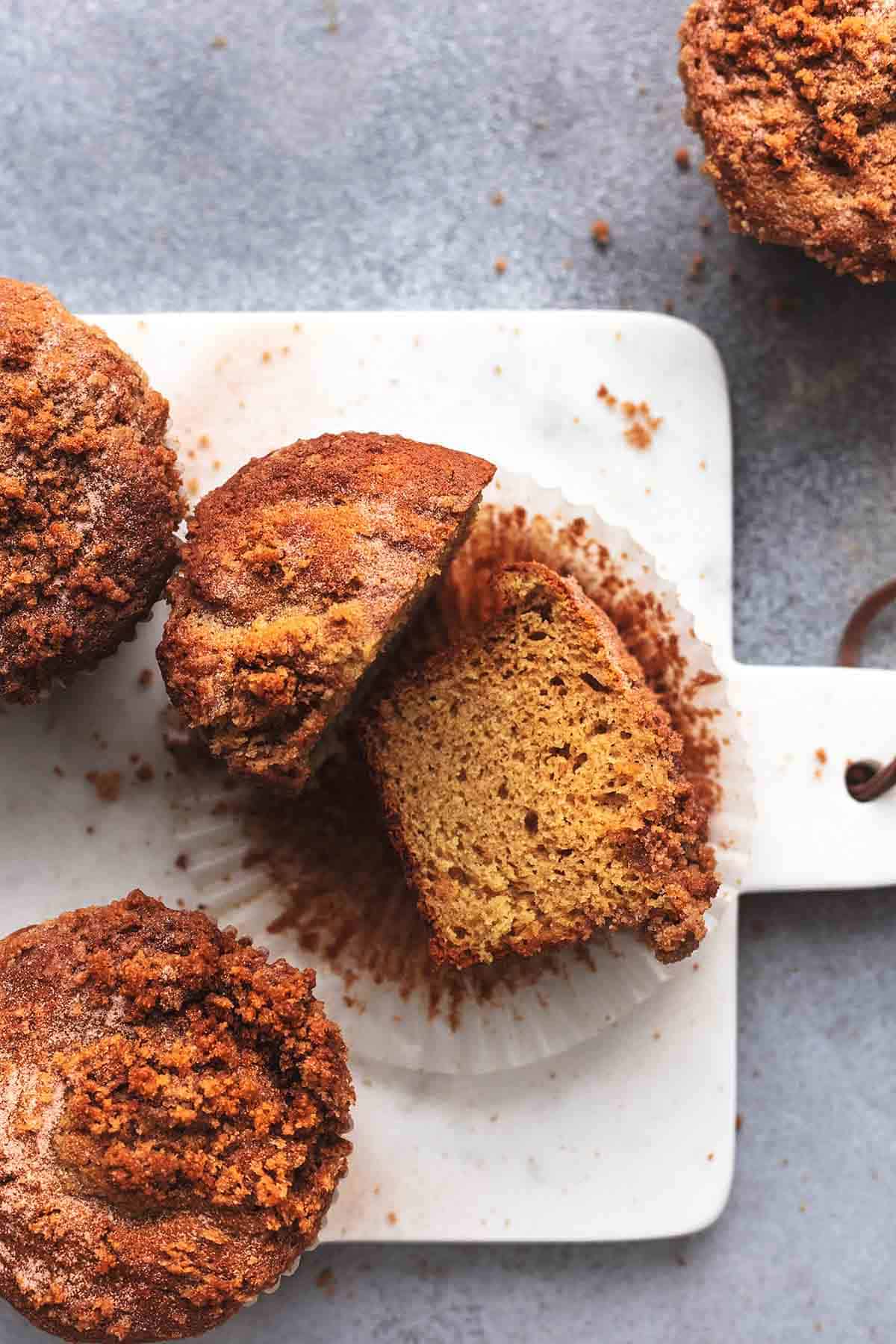 top view of cinnamon streusel muffins with one cut in half.