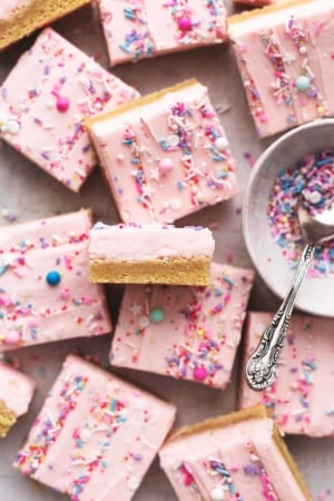 overhead view of sugar cookie bars with pink frosting and sprinkles