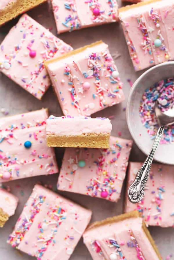 overhead view of sugar cookie bars with pink frosting and sprinkles