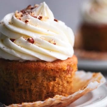 up close view of 3/4 of a single brown cupcake with white frosting