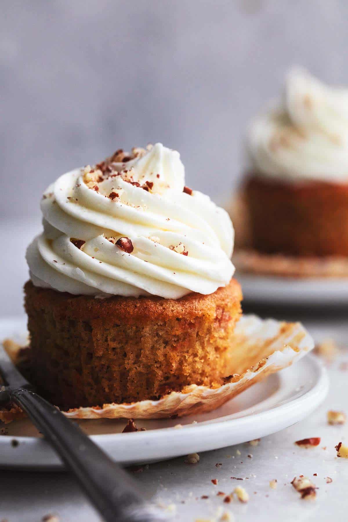 single carrot cupcake unwrapped, on white plate