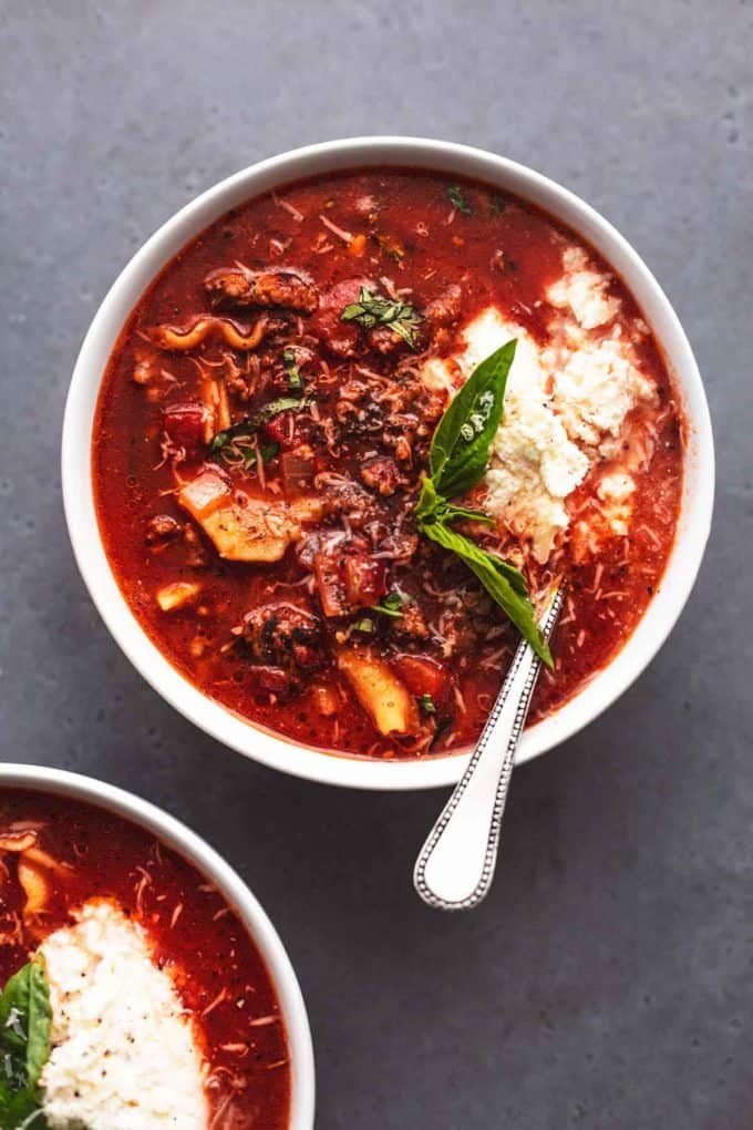 overhead bowl of soup with fresh basil and red tomato broth