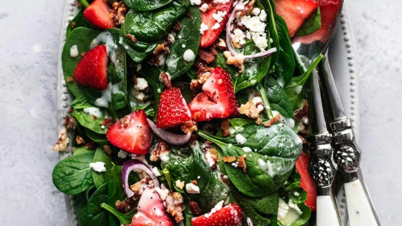 overhead view of strawberry spinach salad with poppy seed dressing