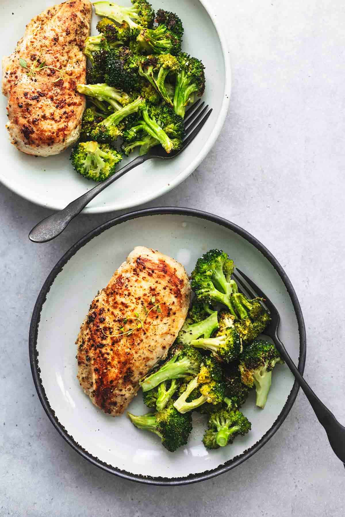top view of two plates with chicken and broccoli skillet on them.