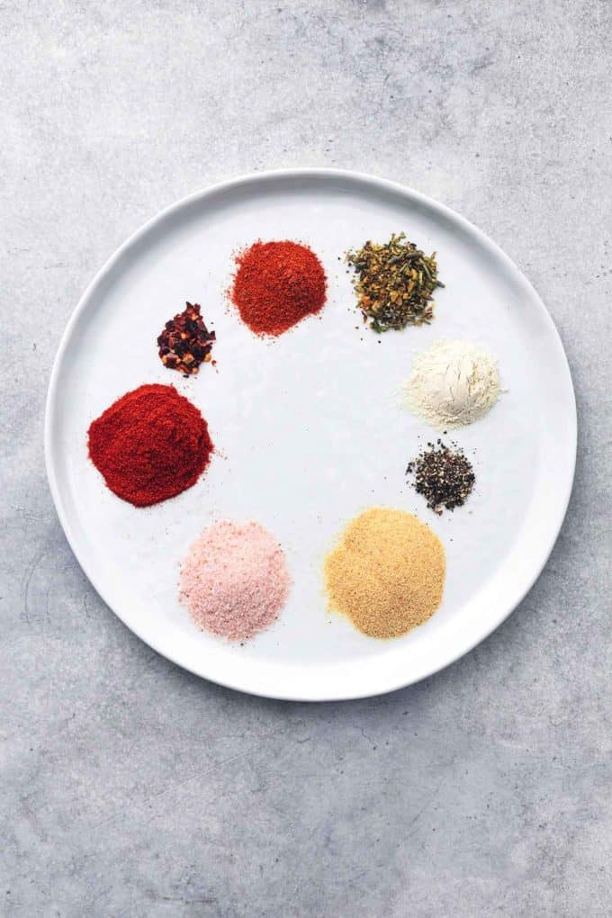 small heaps of individual spices arranged in a circle on a plate