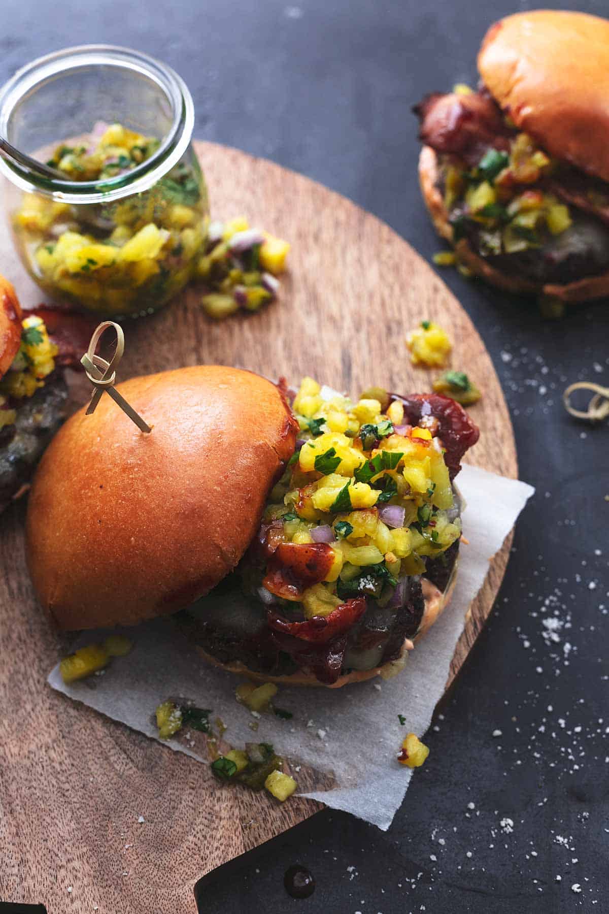 overhead hamburger with pineapple salsa on a cutting board