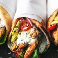 chicken gyro with tzatziki sauce and cucumber salad wrapped in papper