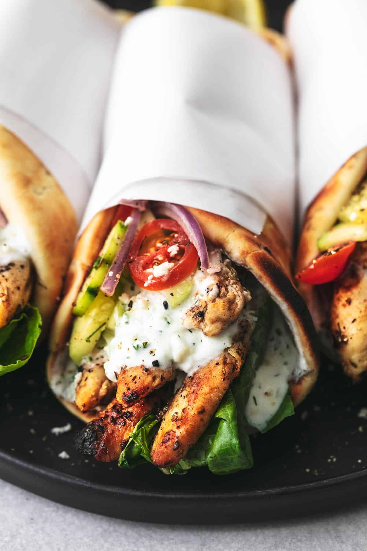 chicken gyro with tzatziki sauce and cucumber salad wrapped in papper