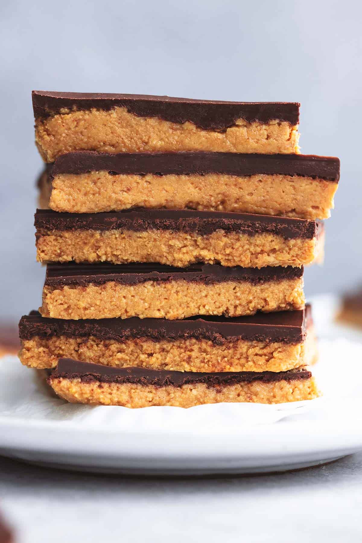 stack of peanut butter bars on top of cupcake liner on top of plate