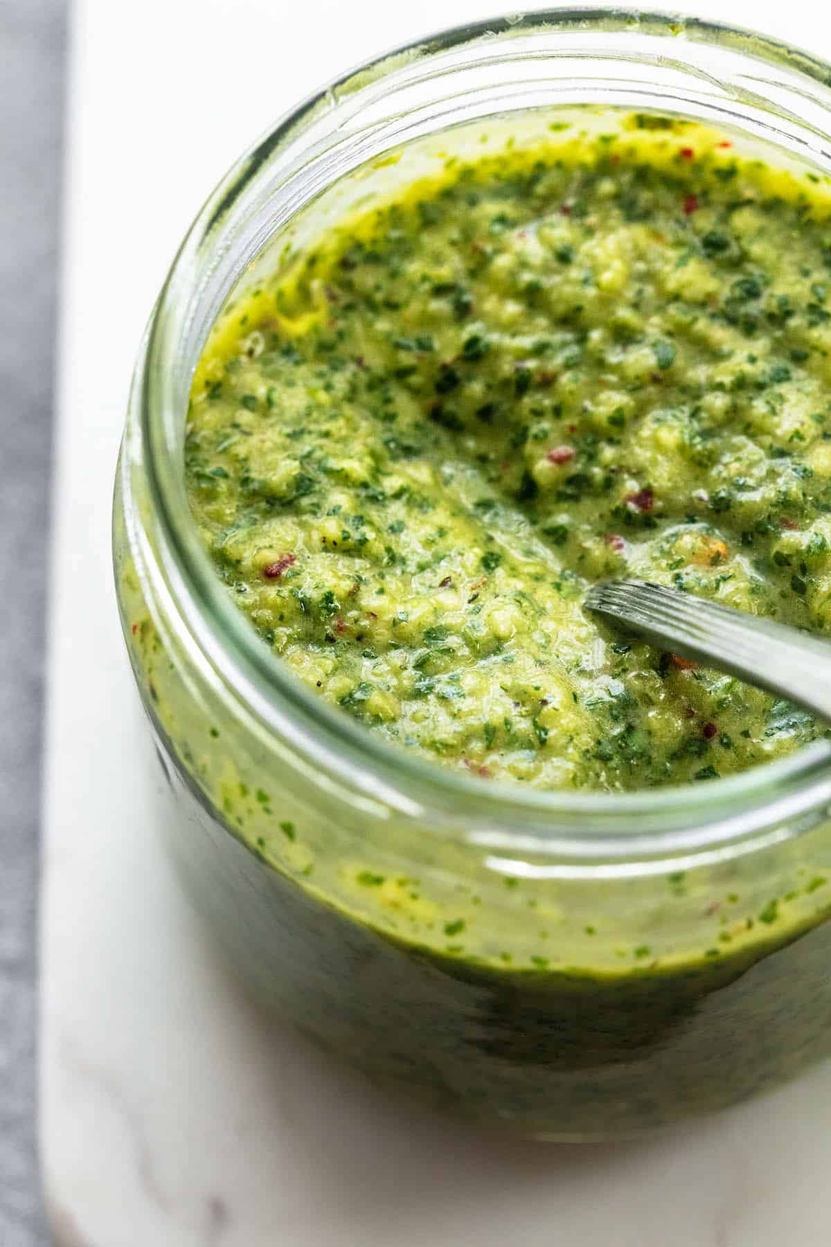 chimichurri sauce in jar with spoon