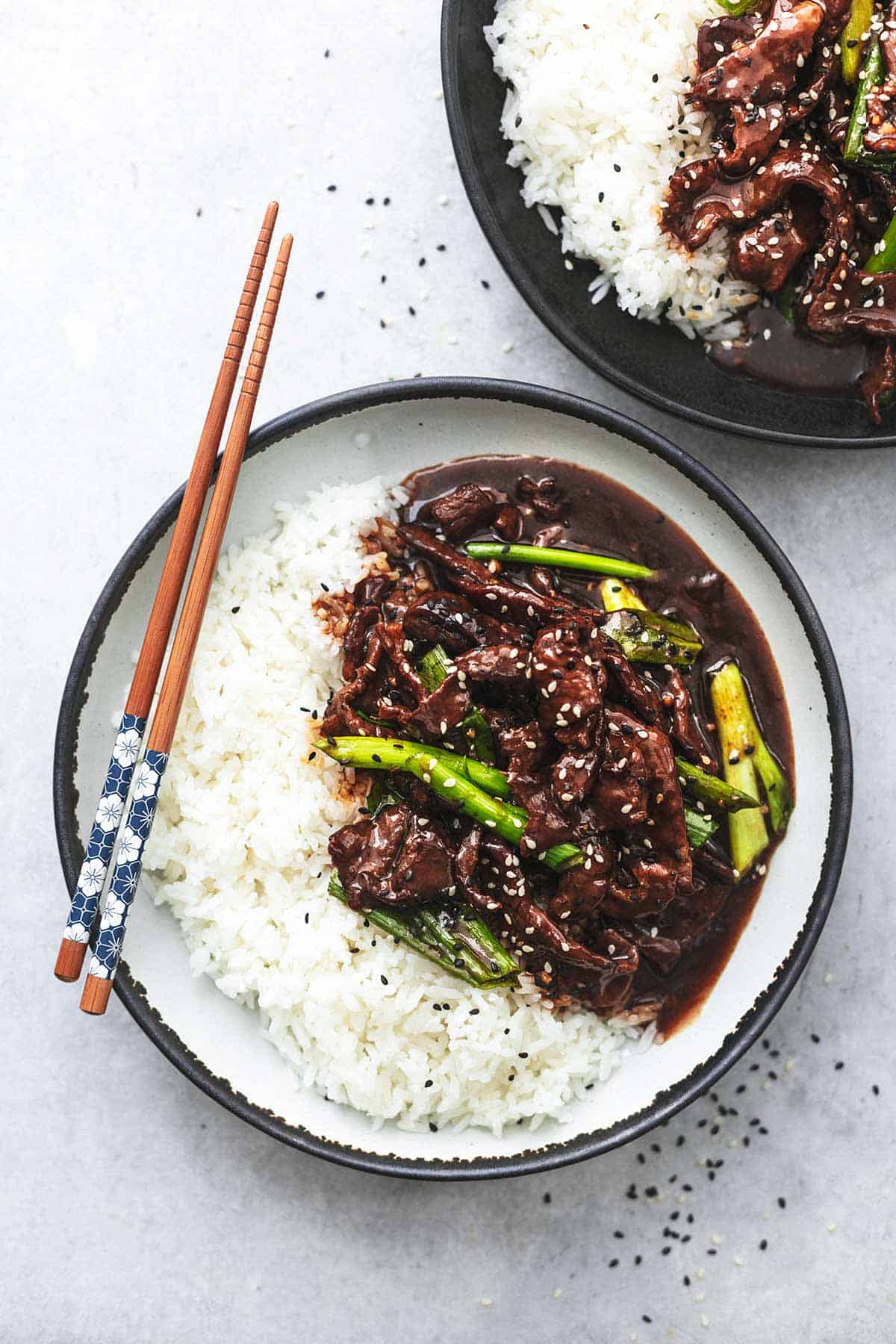 mongolian beef and white rice in bowl with chopsticks