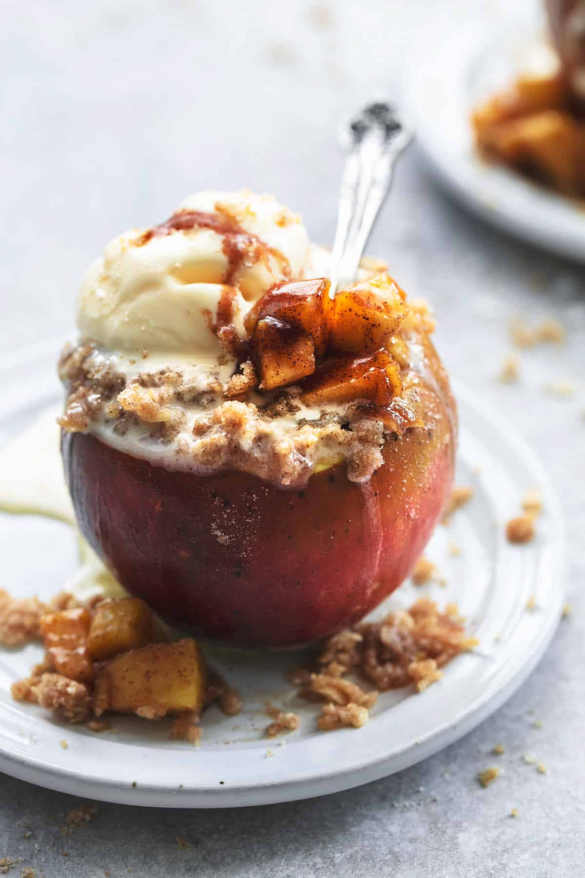 baked apple on plate with spoon in apple