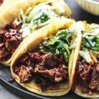 up close beef brisket in tortillas with slaw