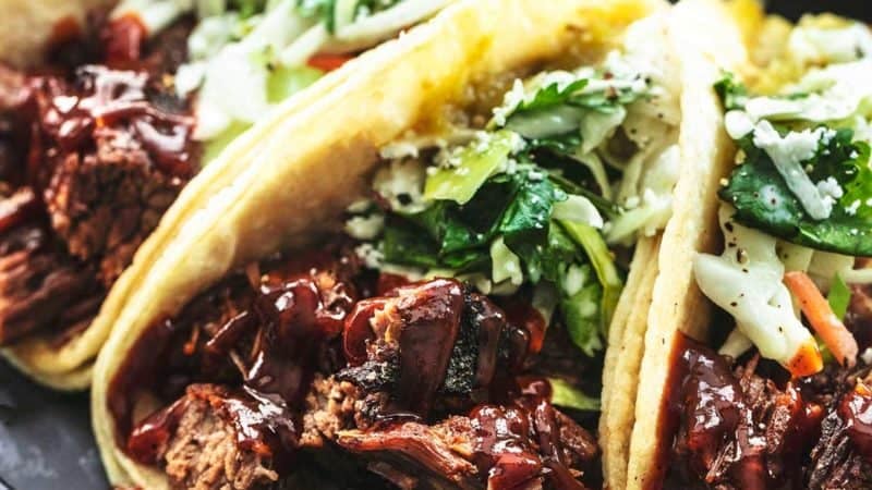 up close beef brisket in tortillas with slaw