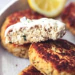 seafood patty cut crosswise and dipped in sauce