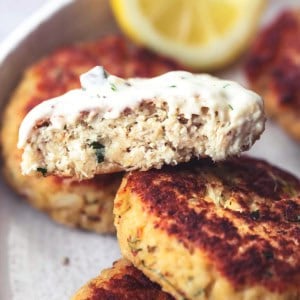 seafood patty cut crosswise and dipped in sauce