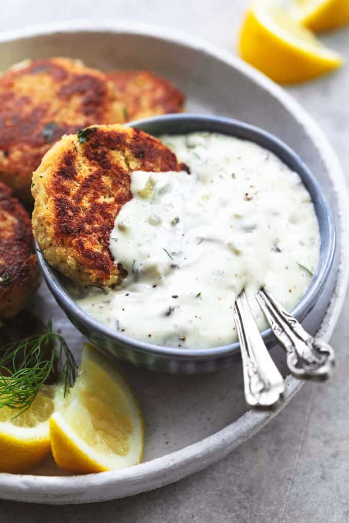 crab cake in tartar sauce in bowl with two spoons