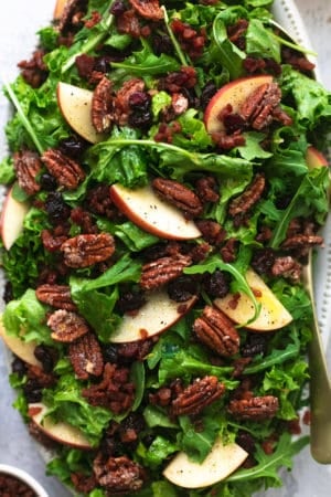 up close lettuce, apple slices, candied pecans, cranberries, and bacon