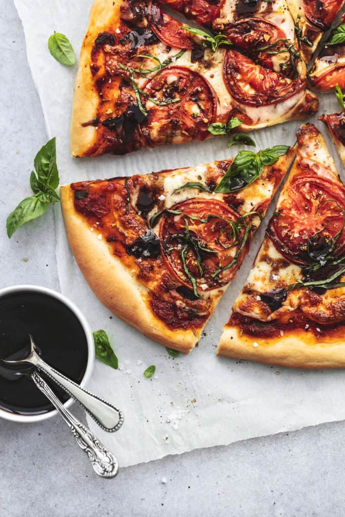sliced margherita pizza with balsamic glaze in bowl