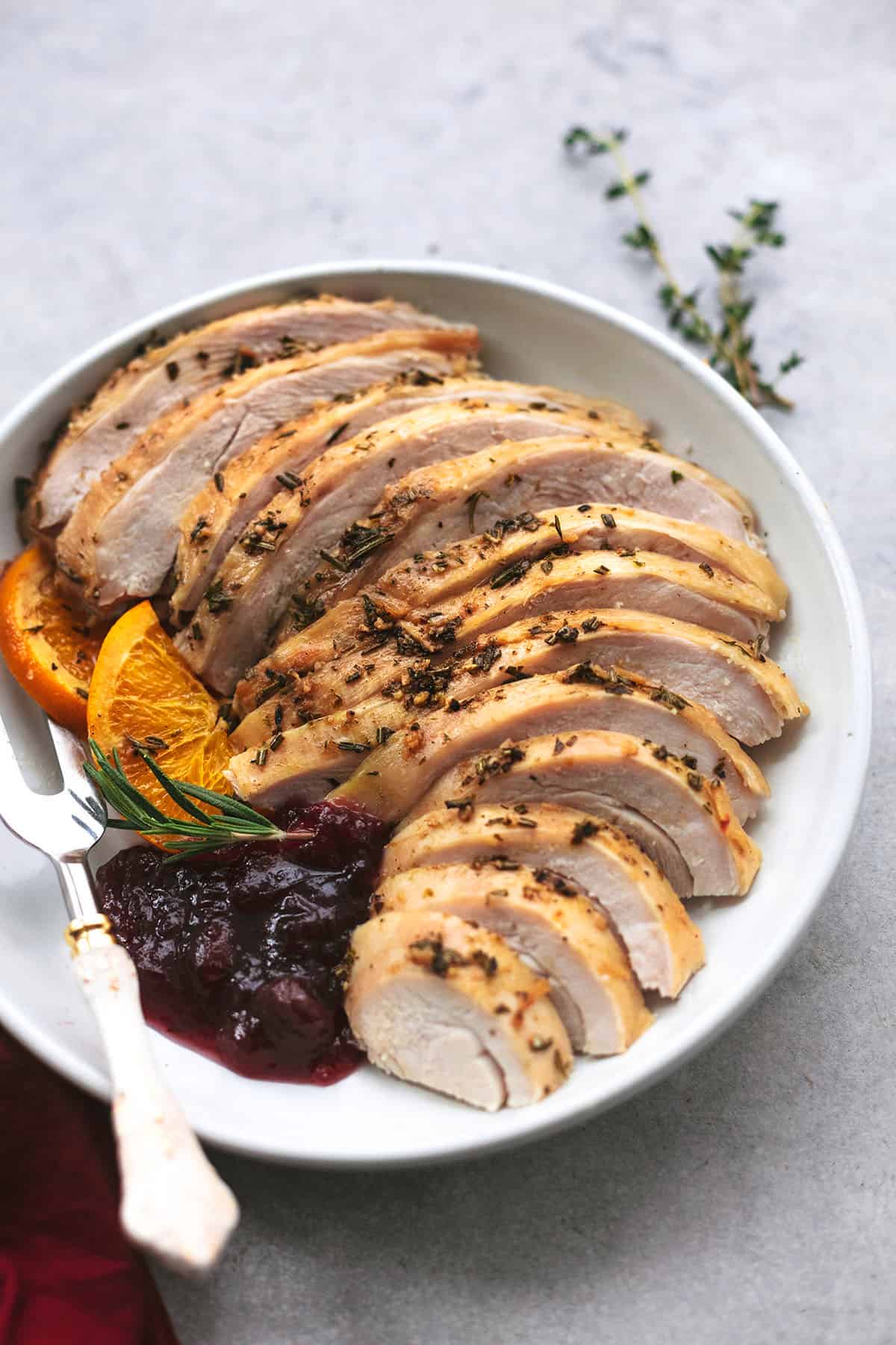 sliced turkey breast with cranberry sauce on plate