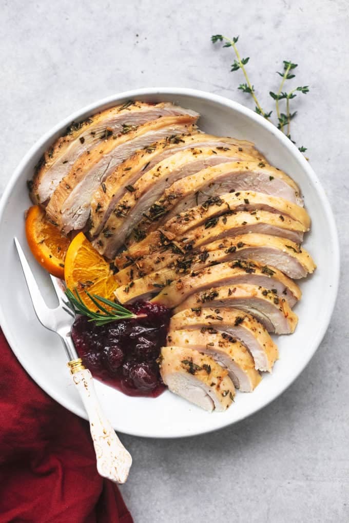 Garlic Herb Roasted Turkey Breast 6 roasted and sliced turkey on platter with cranberry sauce
