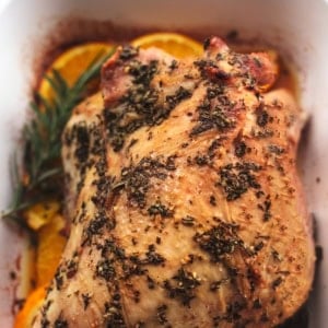 up close baked turkey breast with herbs and orange slices